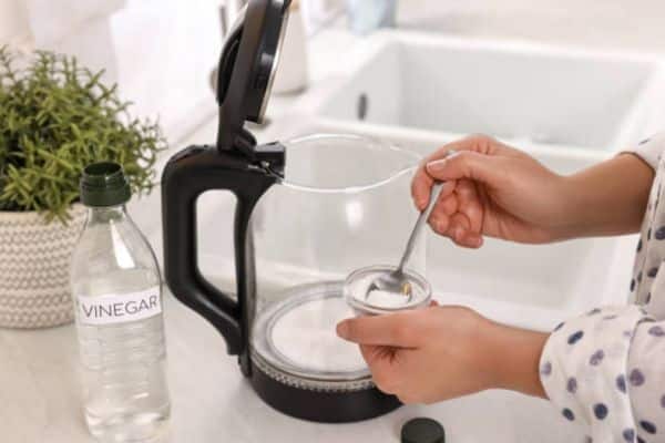 Pour vinegar into the kettle To Clean Kettle With Vinegar And Baking Soda