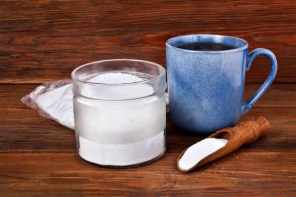 mixing baking soda with warm water to clean coffee maker naturally
