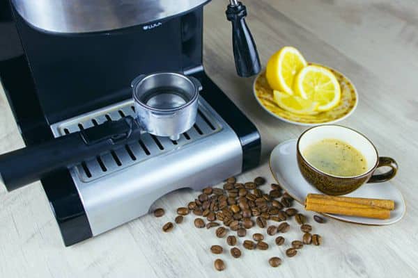 pouring lemon juice solution into coffee maker reservoir for odor free cleaning