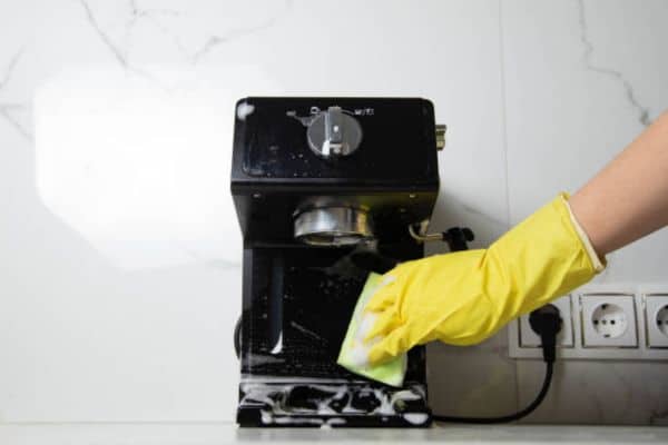 soaking coffee carafe and filter basket in soapy water to remove stains